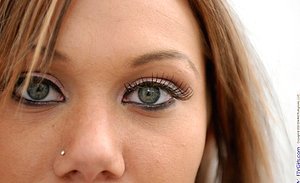 Blue-eyed young gal torturing her beautiful-looking labia on camera
