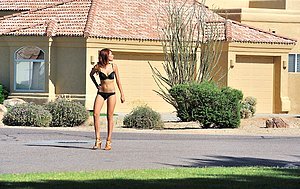 Shameless redhead showing her naked body in an empty parking lot