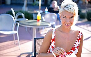 Playful blonde in a revealing dress shows off after her shift
